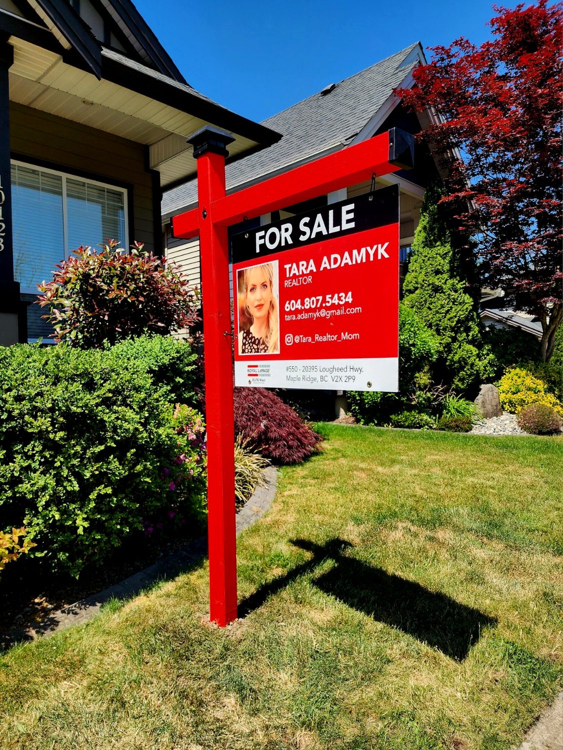 Red real estate sign post installation