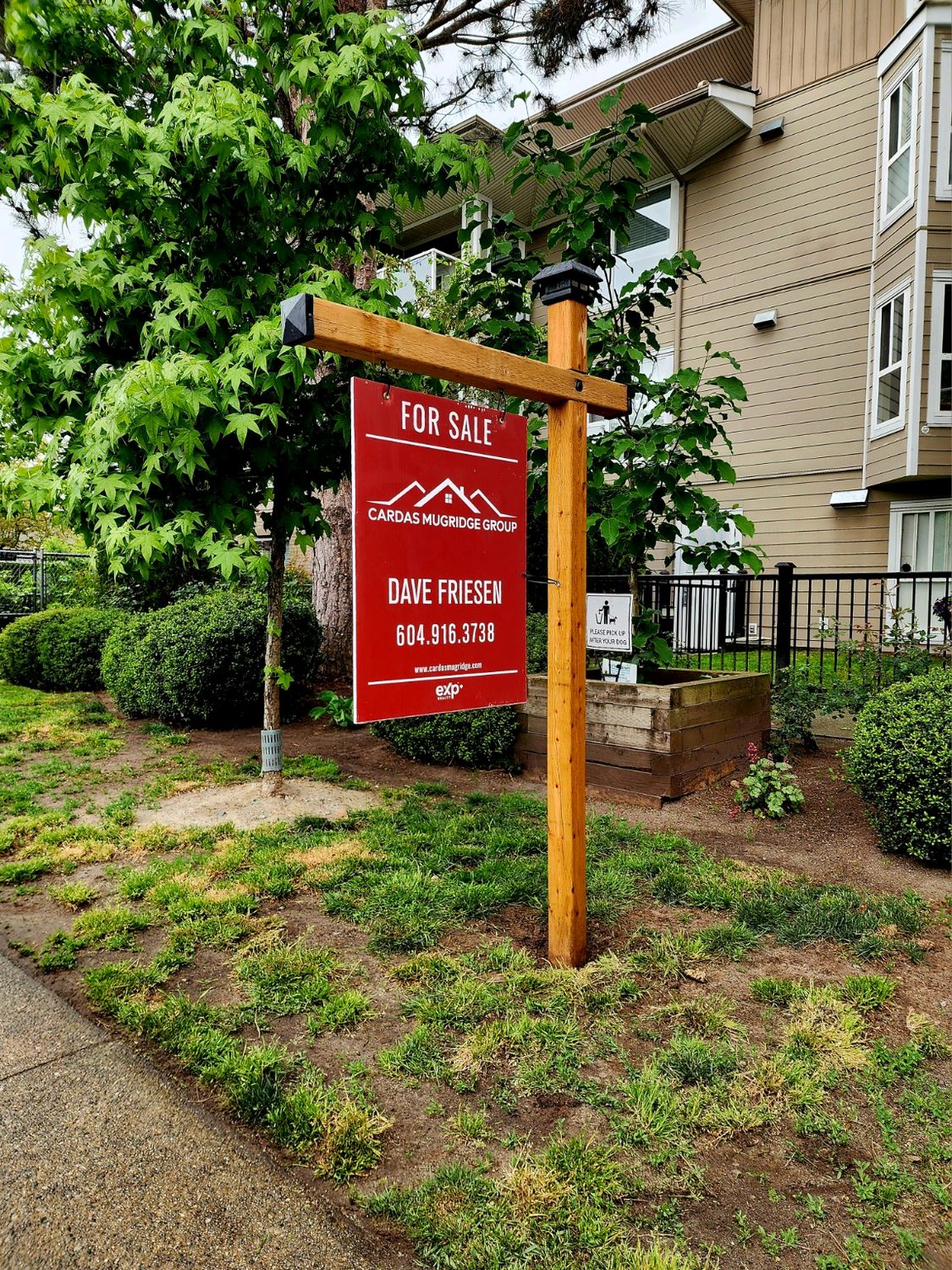Natural wood real estate sign post installation