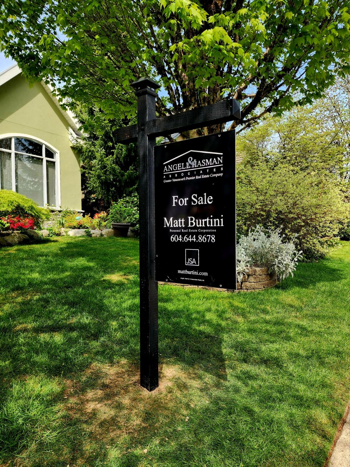 Black real estate sign post installation