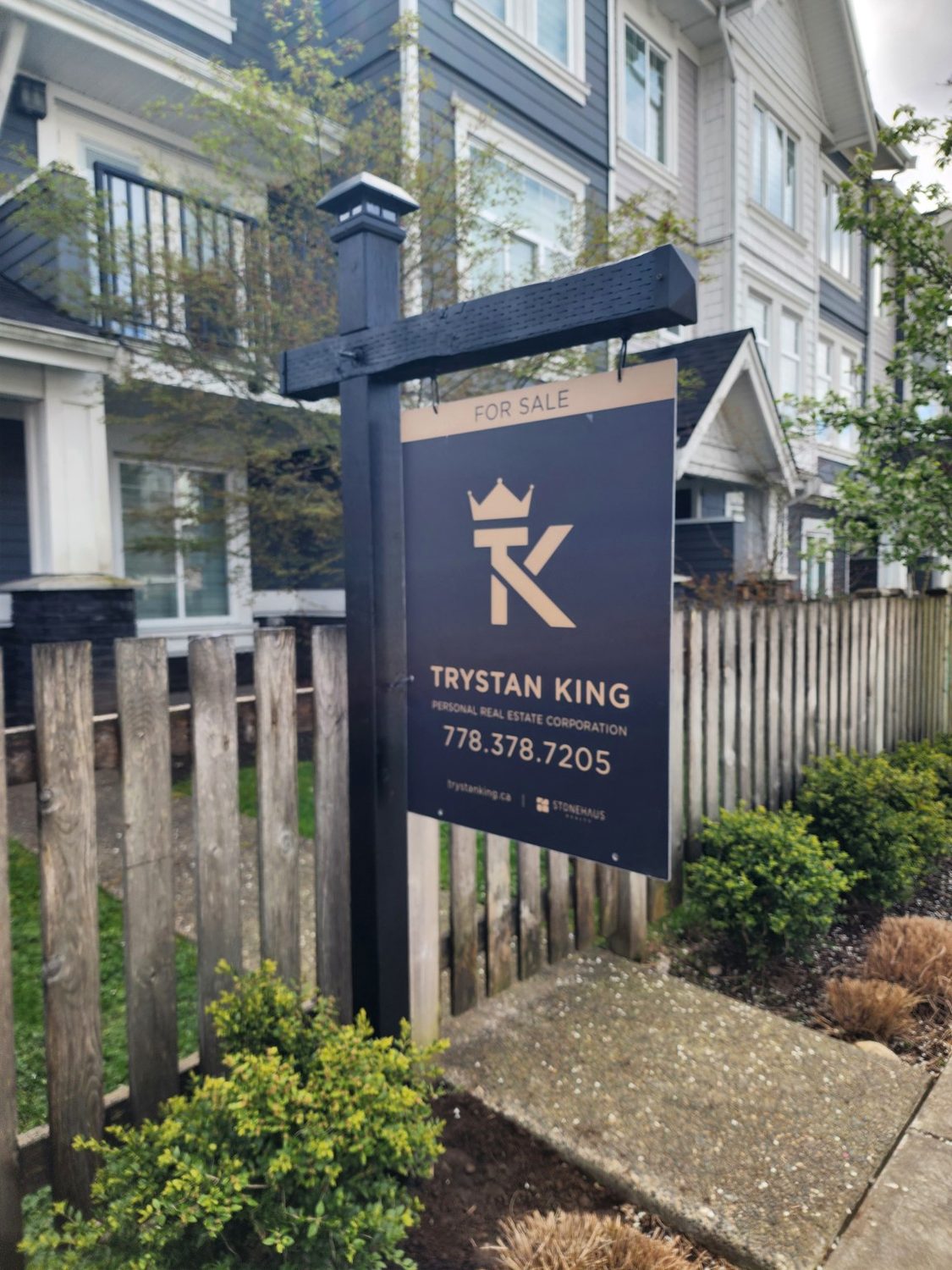 Black custom sign post at townhouse listing