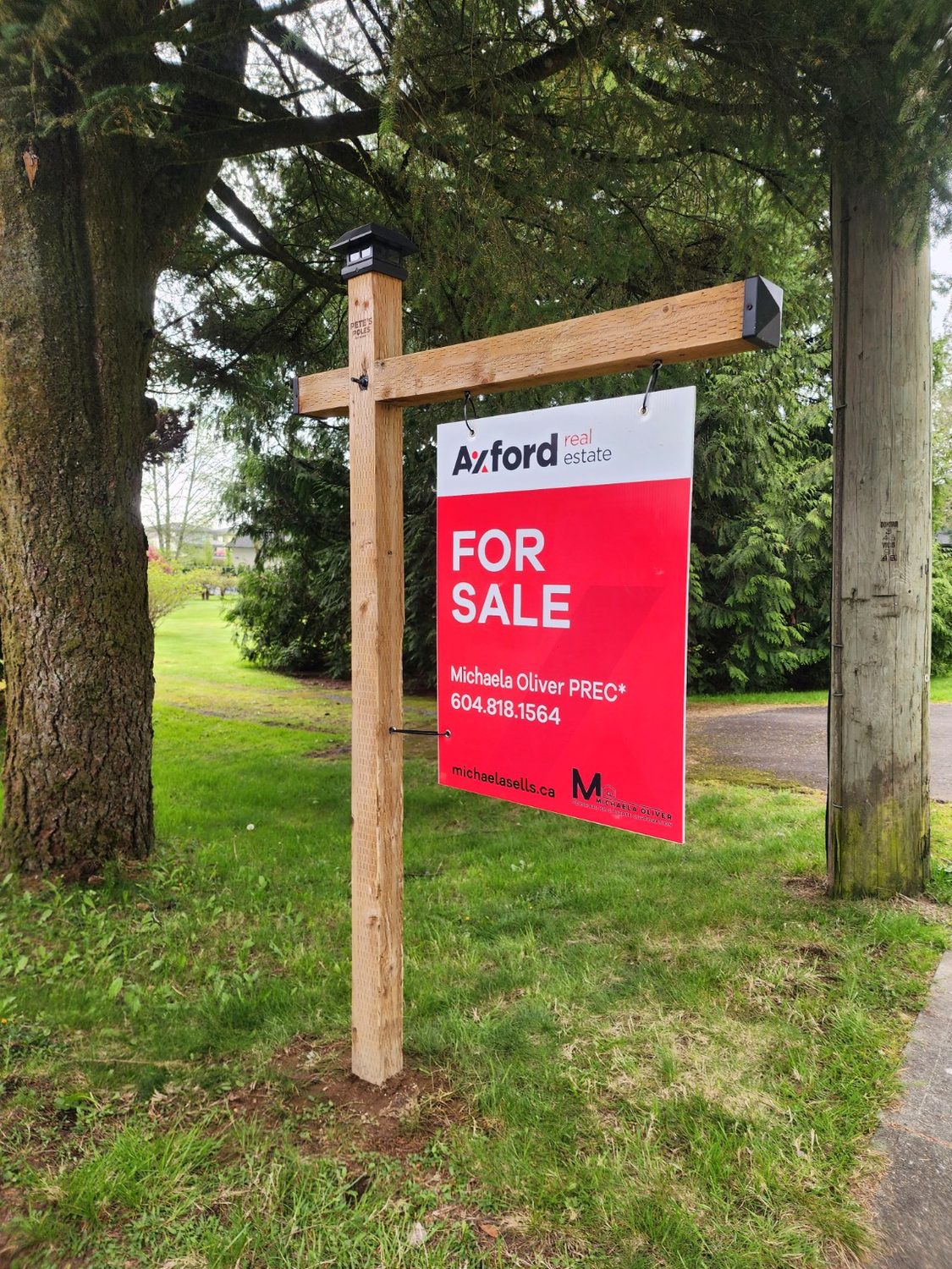 Natural wood real estate sign installation