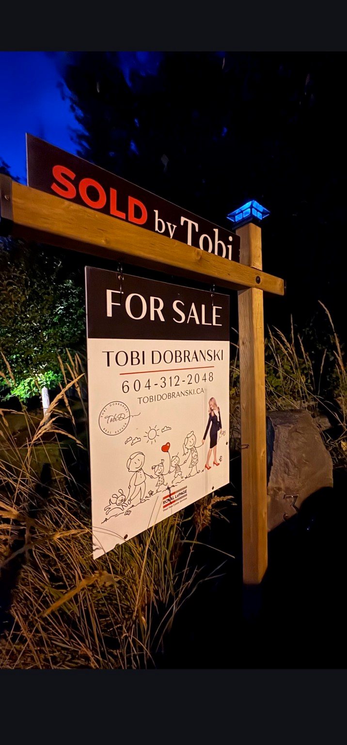 Pete's Poles sign illuminated by its solar light at night